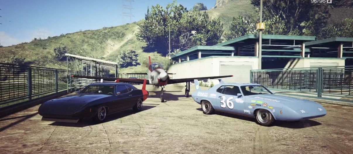 Classic muscle cars and a plane at the airfield